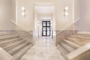 escalera en un edificio con suelo de madera y puerta en Ola Living Diagonal Apartments, en Barcelona