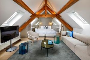 a loft bedroom with a bed and a couch at Hotel Felix in Zürich