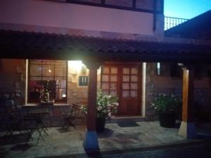 a house with a red door and a patio at Hotel Artea Errota in Zamudio