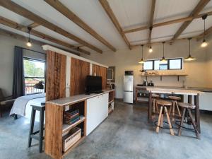 a kitchen with a kitchen island with a counter top at Avo&Oak Guesthouse in George