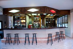 a bar in a restaurant with stools at Kallisti in Ormos Panagias