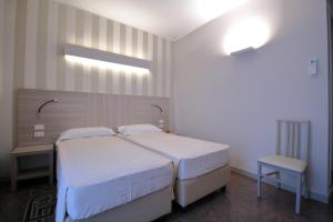 Posteľ alebo postele v izbe v ubytovaní Hotel Vittoria