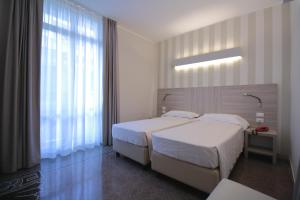 Posteľ alebo postele v izbe v ubytovaní Hotel Vittoria