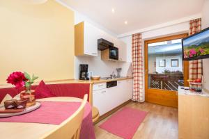 a kitchen and a dining room with a table and a kitchen at Ferienhaus Eva in Flachau