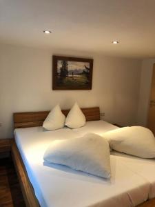 a large white bed with two pillows on it at Haus Oberdorf in Zams