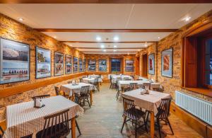 a restaurant with tables and chairs and pictures on the walls at U Musa in Karpacz