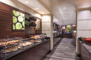 a restaurant with a bakery with pastries on display at La Quinta Inn & Suites by Wyndham San Antonio Riverwalk in San Antonio