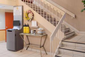 a staircase in a building with a table under it at La Quinta Inn by Wyndham Minneapolis Airport Bloomington in Bloomington