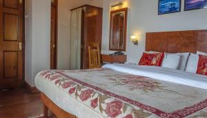 Postel nebo postele na pokoji v ubytování Hotel Shangrila Regency
