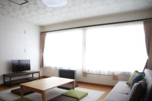 a living room with a couch and a table at THE STAY WAKKANAI in Wakkanai