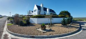 a house on the side of a road at Allview Selfcatering Apartments Jacobsbaai in Jacobs Bay