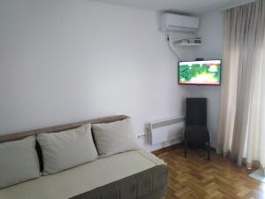 a living room with a couch and a flat screen tv at Apartment Laća in Vrnjačka Banja