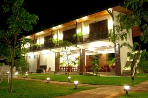 a building with lights in a yard at night at Gamodh Citadel Resort in Anuradhapura