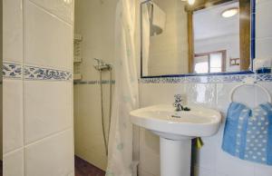a bathroom with a sink and a mirror and a shower at La Casita in Grazalema