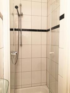 a shower with a glass door in a bathroom at Svg Hotel Kalimera in Ludwigshafen am Rhein