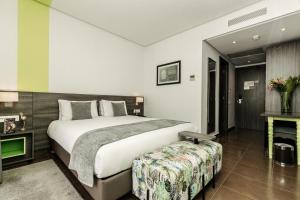 Ein Bett oder Betten in einem Zimmer der Unterkunft Wazo Hotel