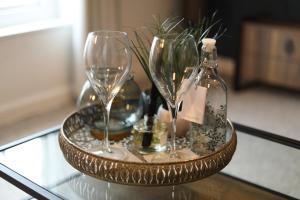 two wine glasses and a bottle on a glass table at Blueberry View-Wyndale-2BR Boutique Worcester in Worcester