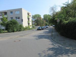 a street with cars parked on the side of the road at Döhren - 2 Single rooms in Hannover