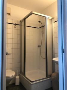 a bathroom with a shower and a toilet at Hotel Göbel in Aachen