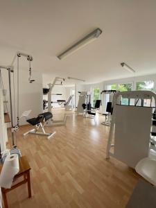 a gym with several exercise equipment in a room at Wohnung mit 2 Einzelzimmer gemeinsamer Küchen/Bad/Balkon-Nutzung in Espelkamp