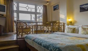 Postel nebo postele na pokoji v ubytování Hotel Shangrila Regency