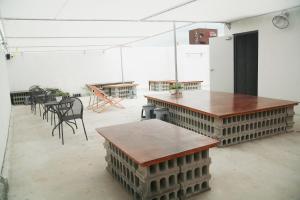 a room with tables and chairs and a refrigerator at Minihotel Poongdaengi in Gyeongju