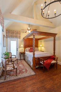 a bedroom with a canopy bed and a chandelier at The Kenwood Inn Bed and Breakfast in Saint Augustine