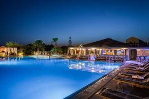 a swimming pool at night with blue lights at Avithos Resort Hotel in Svoronata