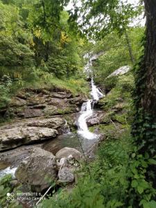 a waterfall in the middle of a river at RIVAROLA in Fanano