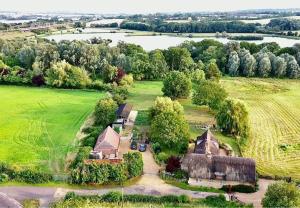 an aerial view of a farm with a barn at Lacewing Lodge in Sharnbrook