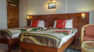 Postel nebo postele na pokoji v ubytování Hotel Shangrila Regency