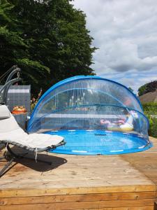 a swimming pool in a dome tent with a chair in front at Nordsee-Koje in Brunsbüttel
