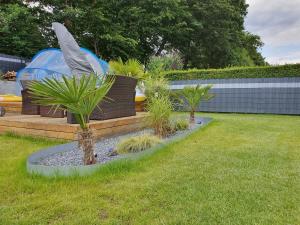 un jardín con una tienda y plantas en un patio en Nordsee-Koje en Brunsbüttel