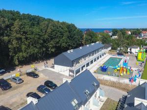 an aerial view of a building with a swimming pool at Apartamenty przy Latarni in Niechorze