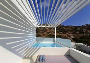 a view of a swimming pool from a house at Relux Ios Hotel in Ios Chora