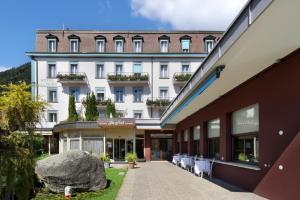 
a large building with a clock on the front of it at Hotel Du Nord in Interlaken
