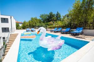 two rubber ducks in the water in a swimming pool at Villa Sunset Sea in Krk