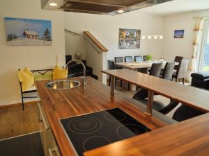 a kitchen with a sink on a wooden table at Casa Alpina in Goldegg