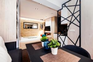 a living room with a table with plants on it at Apartments Casa Đekić in Rovinj