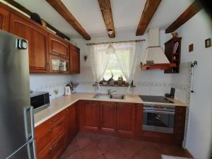 a kitchen with wooden cabinets and a sink at Majcia in Jelenia Góra