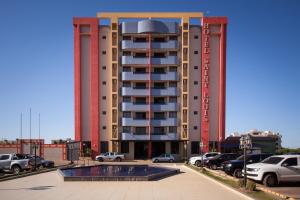 a large building with a pool in front of it at Hotel Saint Louis in Luís Eduardo Magalhães