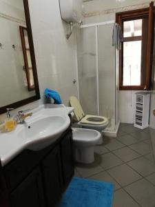 a bathroom with a sink and a toilet and a shower at Villa REBECCA in Solanas