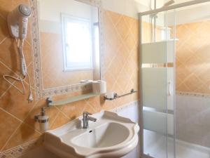 a bathroom with a sink and a shower at Agriturismo Is Cortillaris in Càbras +62 photos