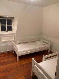 a small room with two beds and a window at Vakantiehuis Villa Zeewolde in Zeewolde +9 photos