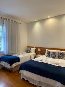 En eller flere senge i et værelse på Pousada e Hostel São Paulo Comfort