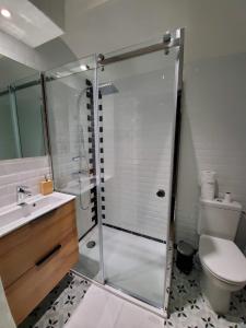 a bathroom with a shower with a toilet and a sink at La Maison des Jonquerets in Jonquerets-de-Livet