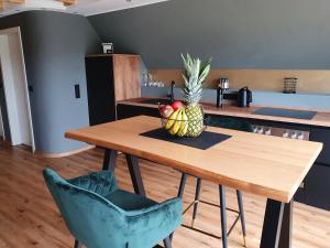 a wooden table with a pineapple on top of it at Moselfeeling co2frei in Cochem