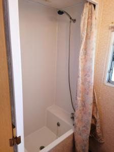 a shower in a bathroom with a shower curtain at Medumi Lake in Medumi