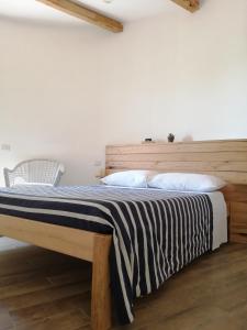 1 dormitorio con 1 cama con cabecero de madera en Il Silos, en Maccarese