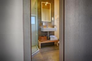 a bathroom with a sink and a mirror at Casa Gemelli Boutique Guesthouse in Victoria